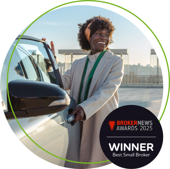 Woman opening car door smiling wearing a long coat